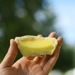 a hand holding a half eaten pastry