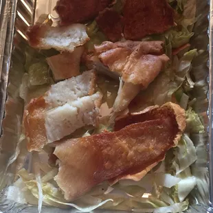 a tray of food with meat and lettuce