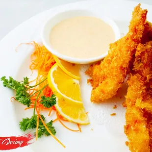  plate of fried fish with a side of dipping sauce