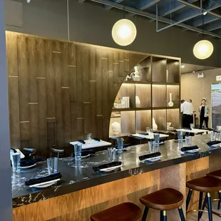 a kitchen with a bar and stools