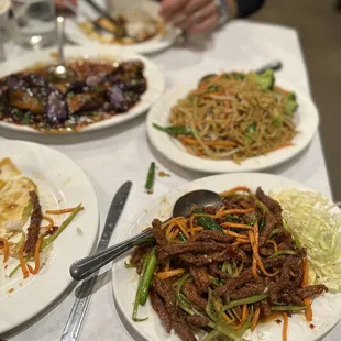 a table with plates of food and utensils