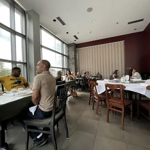 a group of people sitting at a table in a restaurant