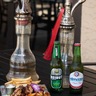 a plate of food and a bottle of beer