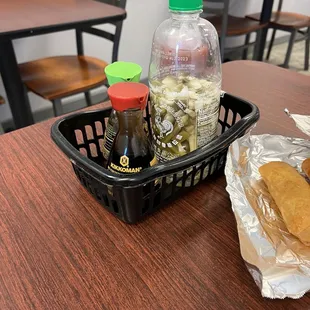 a basket of food and a bottle of ketchup