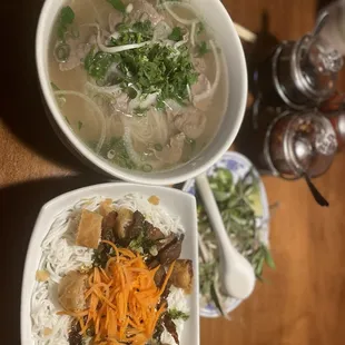 Beef pho and rice noodle bowl with pork and egg roll.
