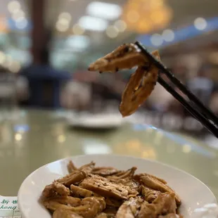 a plate of noodles and chopsticks