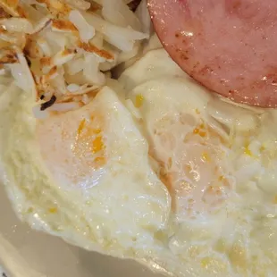 Ham eggs over easy and hashbrown.