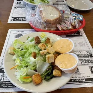 ows a plate of salad and bread