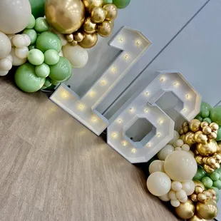 Marquee number and rustic balloon decor  perfect edition for this sweet sixteen hosted at the cypress community center in Cypress CA