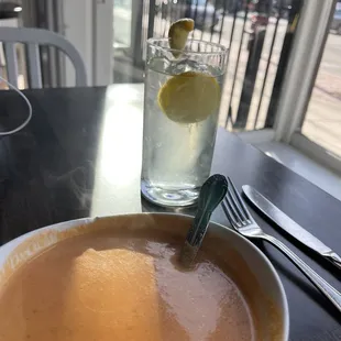 a bowl of soup and a glass of water