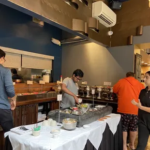 a group of people preparing food in a restaurant