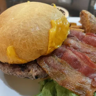 The bacon is overflowing this burger.