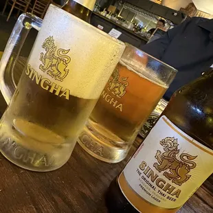 a glass of beer and a bottle of beer