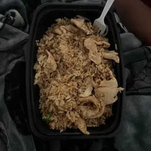 a bowl of rice with chicken and peas