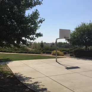 Small basketball court on one end of the park.