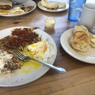 Country fried steak, hash browns, sunny side up eggs, and a biscuit.