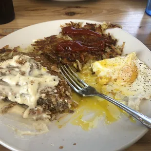 Country fried steak, hash browns, and sunny side up eggs.