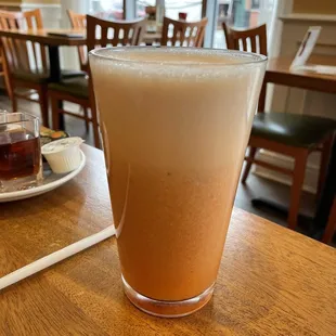 a glass of iced coffee on a table