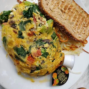 Vegetarian omelet with hall browns and wheat toast - omelet was delicious with nicely cooked veggies