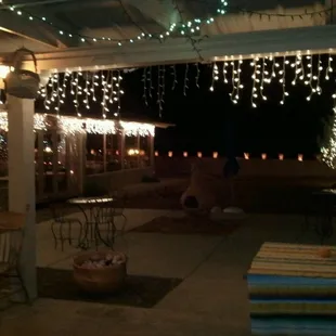 a patio covered in christmas lights