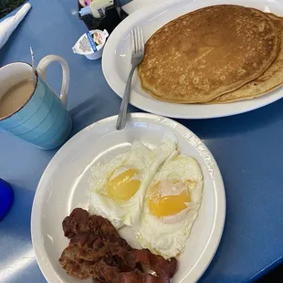 Pancakes, eggs, bacon, and coffee.