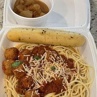 Spaghetti and meatballs, bread stick with fried apples.