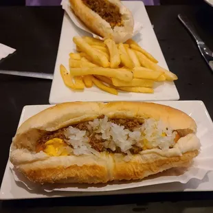 Two chili dogs with fries