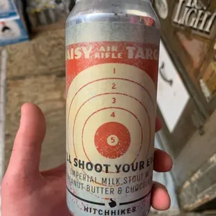 a hand holding a can