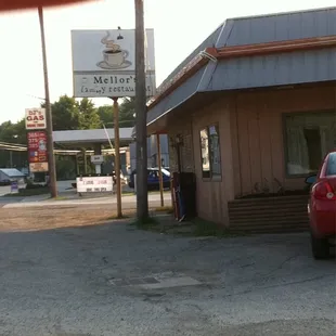 a red car parked in front of the restaurant
