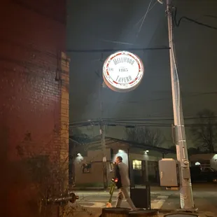 a man walking past barrels
