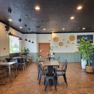 a dining area with tables and chairs