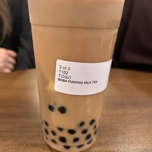 a plastic cup of boba milk tea