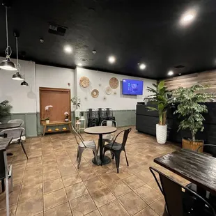 a dining area with tables and chairs