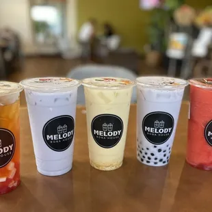 Strawberry lychee green tea with rainbow jelly, taro milk tea, mango jasmine milk tea, taro milk tea with boba, and strawberries and cream