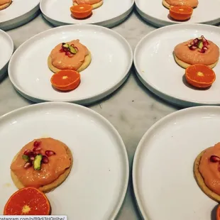 Grapefruit curd on cardamom shortbread coin with pistachio and pomegranate