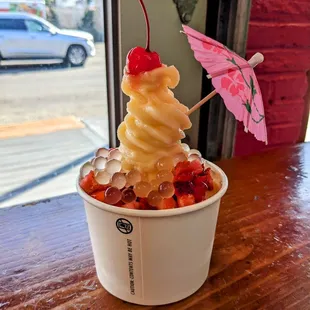 Medium vanilla fro yo with cheesecake, strawberries, boba, and a cherry!