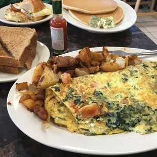 Greek  omelette, pancakes, toast, home fries, breakfast sandwich and toast everything amazing !