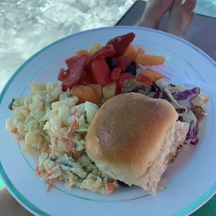 Hawaiian pulled pork slider with slaw, macaroni salad and fruit.