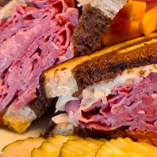 a corned beef sandwich with pickles