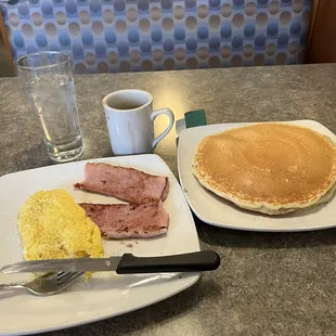 Melrose breakfast special:  2 eggs any style (scrambled),  2 pancakes or short French toast (pancakes) and ham, sausage or bacon  (ham)