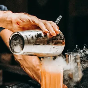 a bartender pouring a drink