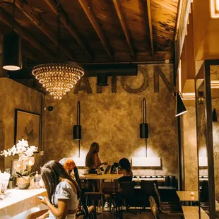 a woman sitting at a table in a restaurant