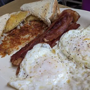 Fried eggs with bacon and hash browns.