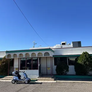 a scooter parked in front of the restaurant