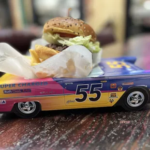 a toy car with a burger in the back
