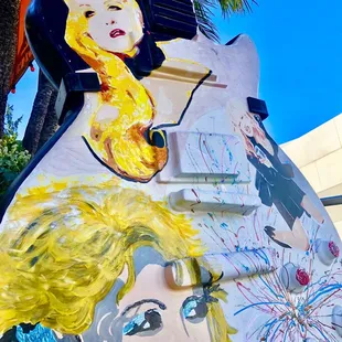 Towering guitar art w/Cyndi Lauper, singer of 'girls just wanna have fun,' images