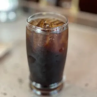 a glass of soda on a counter