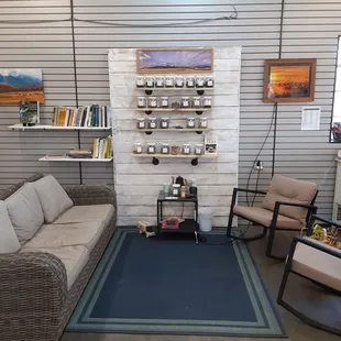 a living room with a couch, chair, coffee table and shelves