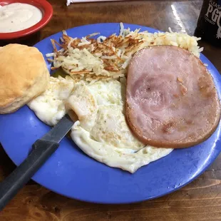 3 eggs over easy, ham, hash browns, biscuit and gravy