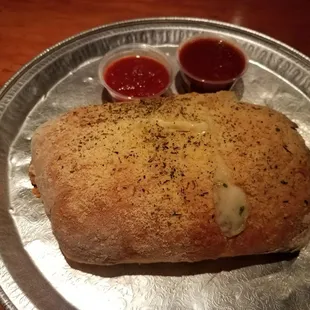 a loaf of bread with sauces